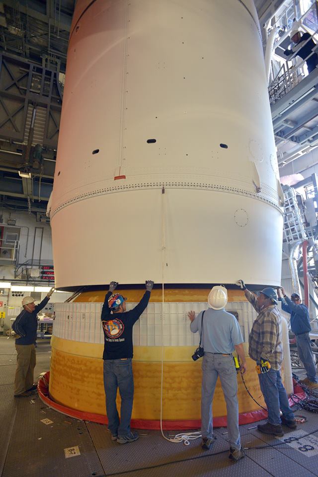 The EFT-1 Orion spacecraft, encapsulated within its payload shroud and topped by the Launch Abort System (LAS), is lowered into position atop the Delta IV Heavy. Photo Credit: NASA