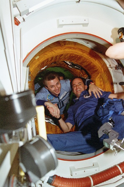 Kevin Chilton (right) greets cosmonaut Yuri Onufrienko during the third shuttle-Mir docking mission in March 1996. Photo Credit: NASA