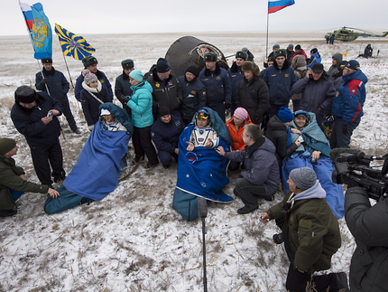 Soyuz TMA-13M crewmen (from left) Alexander Gerst, Max Surayev and Reid Wiseman sit in reclining chairs at the landing site, following their return from 165 days in space. Photo Credit: NASA