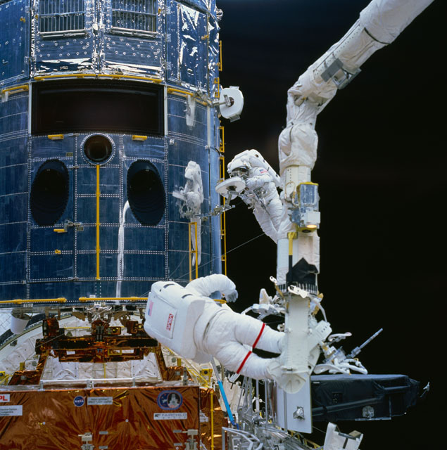 Jeff Hoffman (foreground) and Story Musgrave work to service the Hubble Space Telescope (HST) in December 1993. Photo Credit: NASA