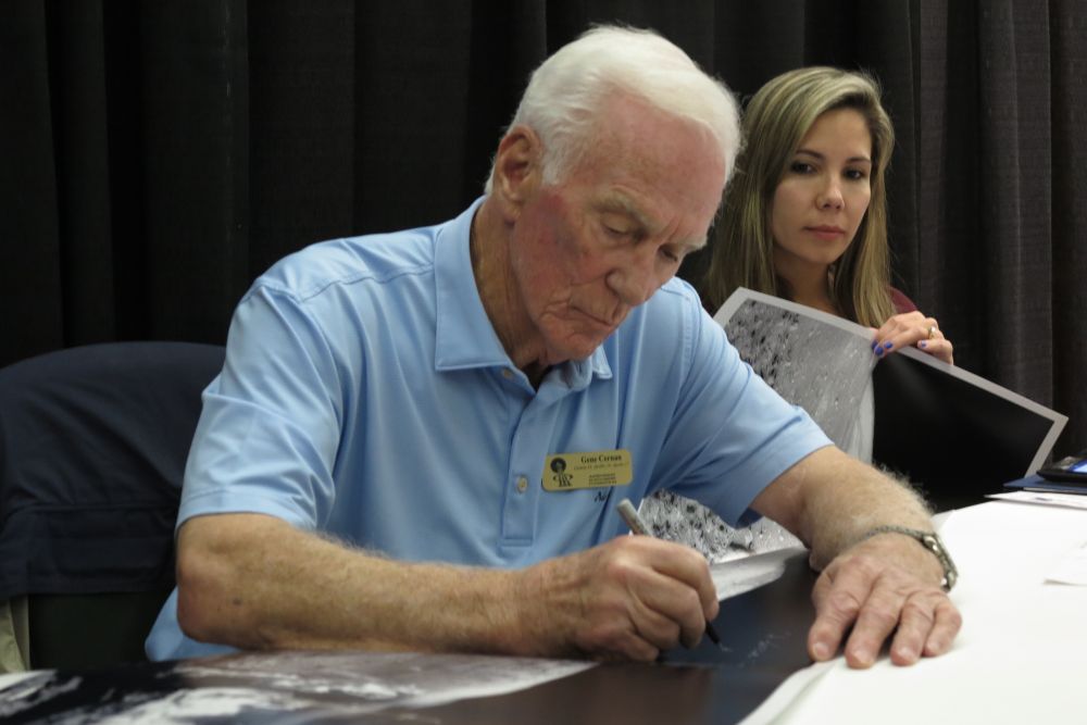 Gemini and Apollo astronaut Capt. Eugene A. Cernan lends his signature to memorabilia during this weekend's Astronaut Autograph and Memorabilia Show, an annual Astronaut Scholarship Event. The event was well-attended and benefits STEM scholars nationwide. Photo Credit: Mark Usciak (permission from the photographer)