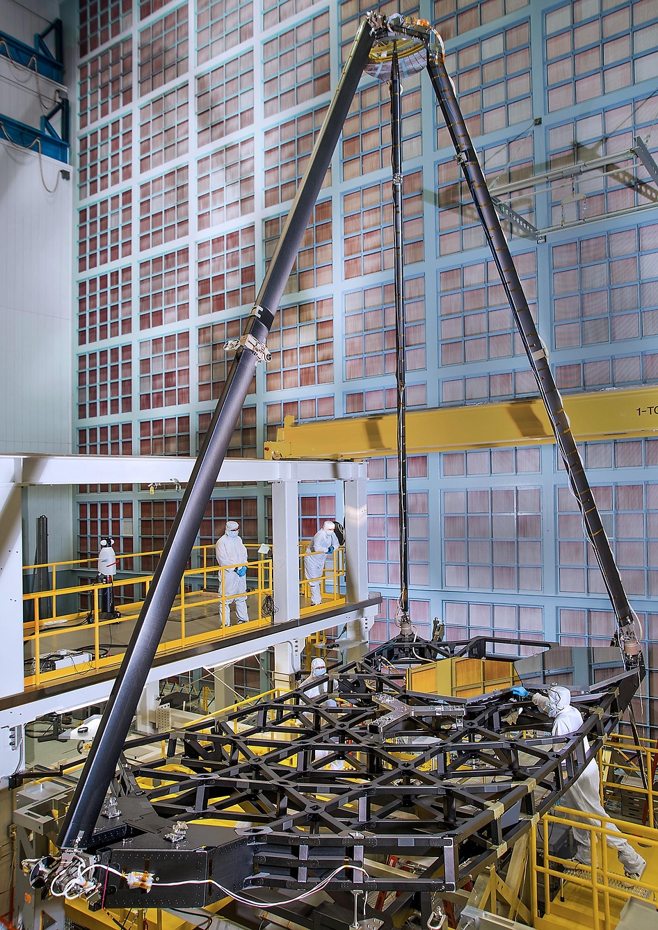 Inside a giant clean room at NASA's Goddard Space Flight Center in Greenbelt, Maryland, the pathfinder telescope, a practice section of the James Webb Space Telescope, stands fully assembled. Teams of engineers built and aligned the pathfinder telescope to rehearse assembly and testing before the actual telescope is built.  Credit: NASA/Chris Gunn