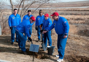 Watched by their backup crew, Anton Shkaplerov, Terry Virts and Samantha Cristoforetti participate in the traditional tree-planting ceremony at Baikonur. Photo Credit: NASA
