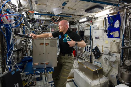 ESA astronaut Alexander Gerst installs a high-speed camera and other hardware into the Electromagnetic Levitator on the International Space Station. Image Credit: NASA