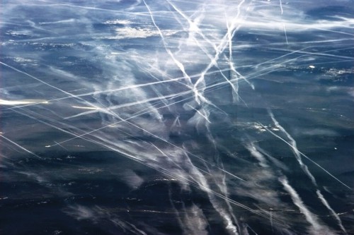 The interactions between clouds and aerosols are illustrated in this image, taken by retired astronaut Chris Hadfield onboard the International Space Station. It shows contrails produced by aircraft (bright streaks) over the ocean. Image Credit: NASA/Chris Hadfield