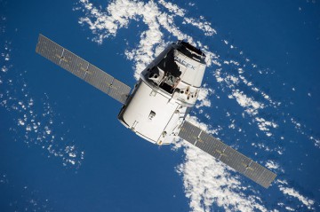 The CRS-4 Dragon spacecraft approaches the International Space Station (ISS) for berthing in September 2014. Note the cylindrical, unpressurized "Trunk", equipped with solar arrays, and topped by the recoverable cargo capsule. Photo Credit: NASA 