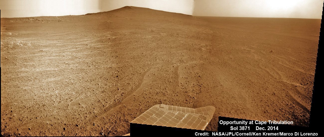 NASA’s Opportunity Mars rover scans to the summit of Cape Tribulation less than 100 meters distant in mid-December 2014.  Beyond lie caches of clay minerals. The scene shows impact breccias and thin soil cover with cobbles over bedrock.  This navcam camera photo mosaic was assembled from images taken on Sol 3871, Dec. 13, 2014 and colorized.  Credit: NASA/JPL/Cornell/ Ken Kremer - kenkremer.com/ Marco Di Lorenzo