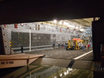 Orion begins to make it way down the USS Anchorage's ramp. Photo Credit: Francis French