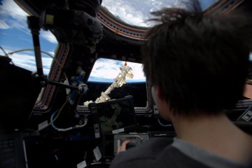 European Space Agency (ESA) astronaut Samantha Cristoforetti is pictured inside the multi-windowed cupola, training for Dragon's CRS-5 arrival. Photo Credit: Twitter @AstroSamantha