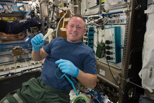 NASA astronaut Barry "Butch" Wilmore holds the ratchet recently created by the 3D printer installed on the International Space Station. Photo Credit: NASA