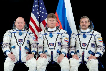 Gennadi Padalka (center) is presently the world's most seasoned space traveler. By the time he returns to Earth on 12 September, he will have accrued 878 days, or 2.4 years, of his life away from the Home Planet. He is flanked by One-Year crewmen Scott Kelly (left) and Mikhail Kornienko. Photo Credit: NASA