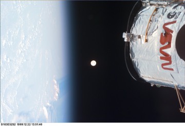 Spectacular view of the top of the Hubble Space Telescope, the limb of Earth and a full Moon, as captured by one of the STS-103 astronauts. Photo Credit: NASA