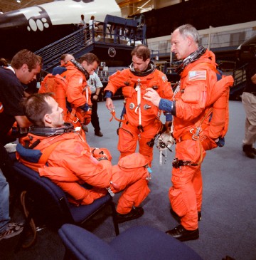 Astronauts Steve Smith (seated) and (from left) Jean-Francois Clervoy, John Grunsfeld and Claude Nicollier discuss procedures before a shuttle training exercise. Photo Credit: NASA