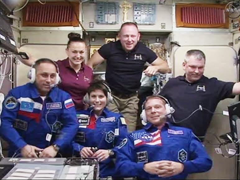 In the front row, from left are the newest Expedition 42 crew members Anton Shkaplerov, Samantha Cristoforetti and Terry Virts. In the back are Elena Serova, Commander Barry Wilmore and Alexander Samokutyaev. They are in the Zvezda service module for a traditional crew greeting ceremony with family and mission officials on the ground. Credit: NASA TV​