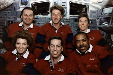 The STS-63 crew consisted of (front left, from left) Eileen Collins, Jim Wetherbee and Bernard Harris and (back row, from left) Vladimir Titov, Mike Foale and Janice Voss. Photo Credit: NASA