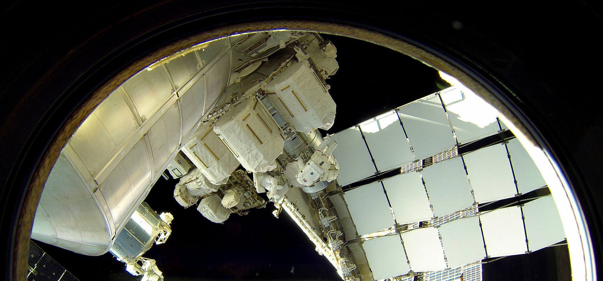 Expedition 41 spacewalkers Reid Wiseman (right) and Alexander Gerst perform "buddy checks" of each other's suits and tethers at the start of EVA-27. Photo Credit: NASA