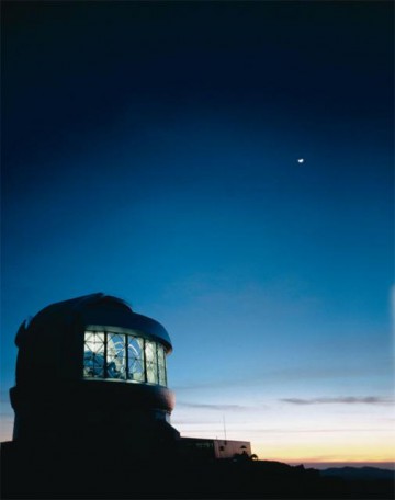 An exterior view of the Gemini South Telescope, below a crescent Moon. Image Credit: Gemini Observatory