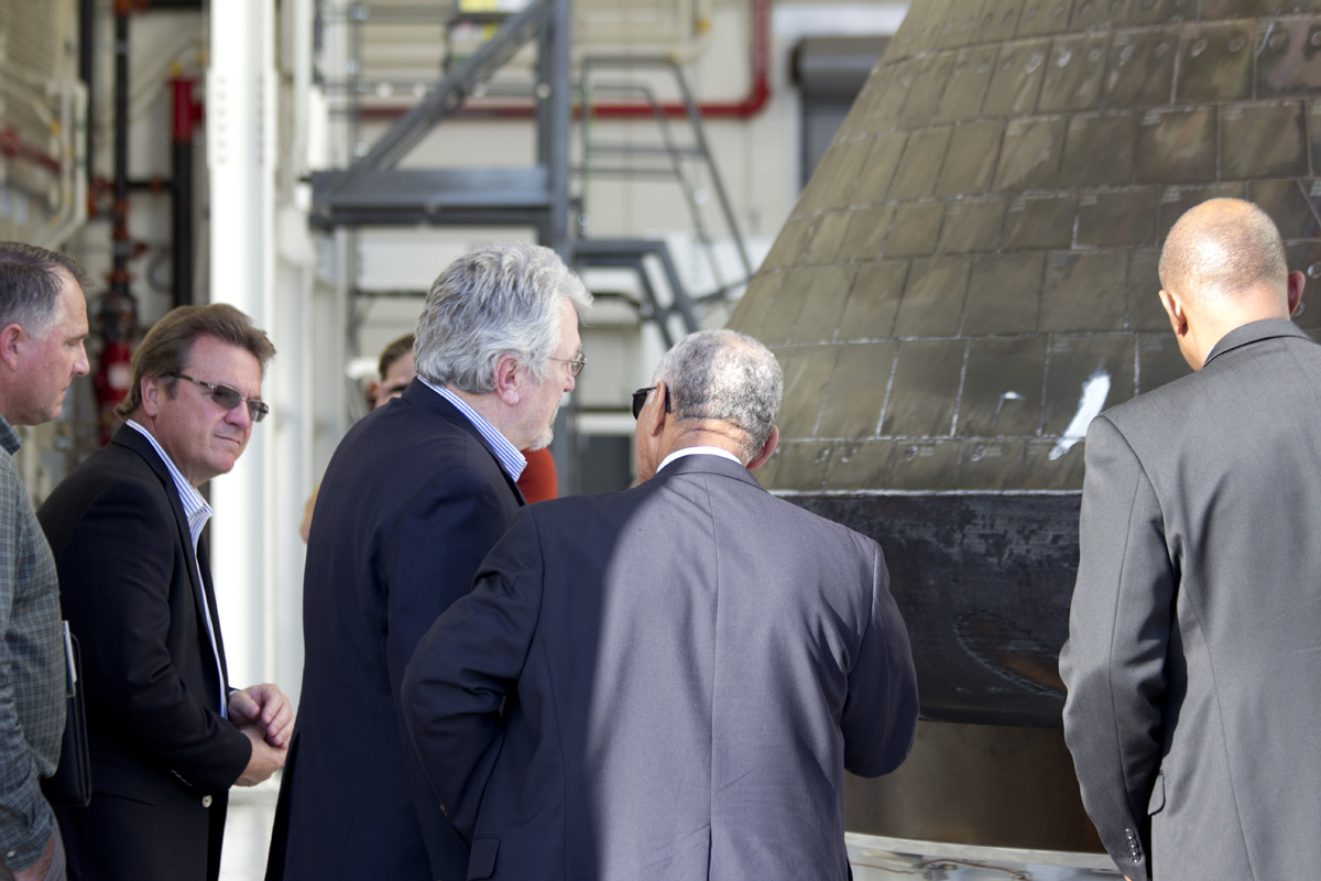 NASA Administrator Charles Bolden (center) visits the Orion EFT-1 capsule at the Kennedy Space Center on Jan. 6, 2015 for his first look at the capsule and how it fared since its first aunch and ocean recovery on Dec. 5, 2014.  Credit: Jeff Seibert/AmericaSpace