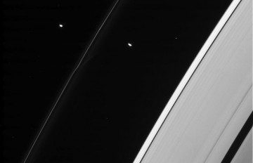 Two of Saturn's shepherd moons, Pandora and Prometheus, which orbit on either side of the narrow F ring. Similar moonless or moons may also be orbiting in the rings of J1407b. Image Credit: NASA/JPL
