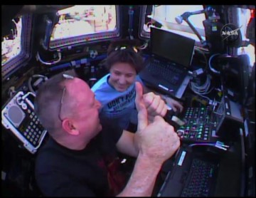 Expedition 42 Commander Barry "Butch" Wilmore and Flight Engineer Samantha Cristoforetti celebrate their success in the moments after capturing Dragon. Photo Credit: NASA, with thanks to Mike Barrett