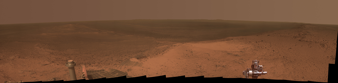Hilltop Panorama Marks Mars Rover's 11th Anniversary. This panorama is the view NASA's Mars Exploration Rover Opportunity gained from the top of the "Cape Tribulation" segment of the rim of Endeavour Crater. The rover reached this point three weeks before the 11th anniversary of its January 2004 landing on Mars. The component images were taken with Opportunity's panoramic camera (Pancam) during the week after the rover's arrival at the summit on Jan. 6, 2015, Sol 3894. The U.S. flag printed on the rover's rock abrasion tool is intended as a memorial to victims of the Sept. 11, 2001, attacks on the World Trade Center in New York.  Credit:  NASA/JPL-Caltech/Cornell Univ./Arizona State Univ. 