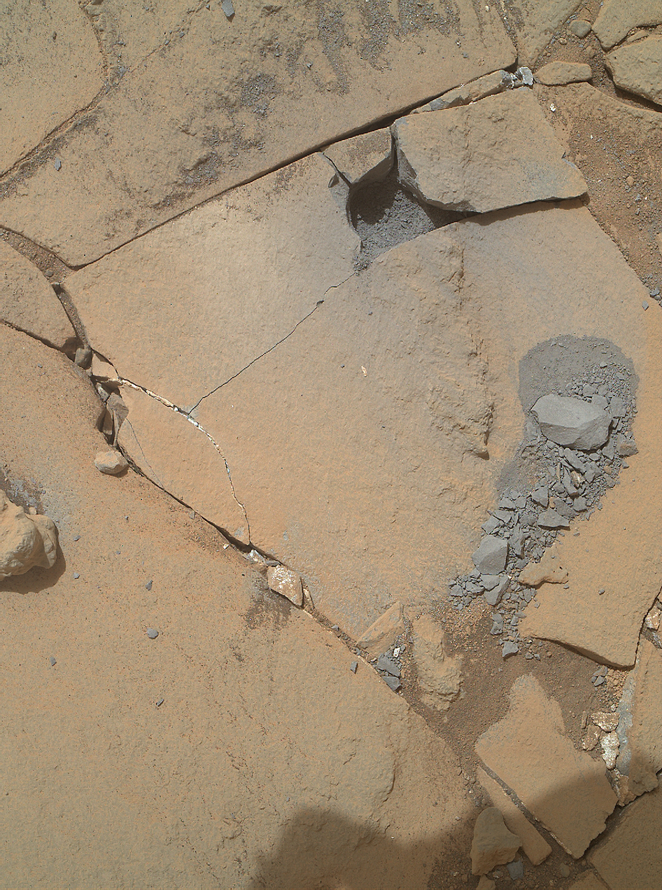 This Jan. 13, 2015, view from the Mars Hand Lens Imager on NASA's Curiosity Mars rover shows outcomes of a mini-drill test to assess whether the "Mojave" rock is appropriate for full-depth drilling to collect a sample. Cracking of the rock has made freshly exposed surfaces available for inspection.  Credit:  NASA/JPL-Caltech/MSSS