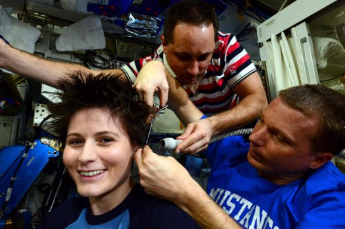 ESA astronaut Samantha Cristoforetti getting a haircut by colleagues Terry Virts and Anton Shkaplerov. Photo Credit: Terry Virts / NASA (@AstroTerry via Twitter)