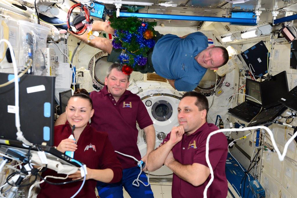Member of the Expedition 42 crew onboard the International Space Station celebrating Russian Christmas with a video call to friends and family and an Orthodox choir in Moscow. Photo Credit: NASA