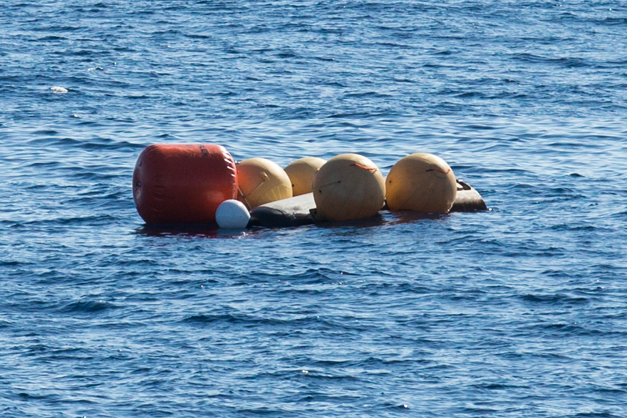Home safe: ESA's IXV vehicle, held afloat by balloons, awaits its recovery in the Pacific Ocean. Photo Credit: ESA–P. Navone