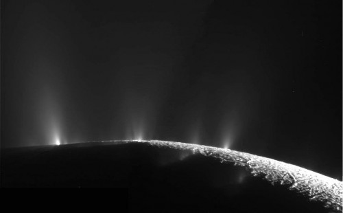 The geysers of Enceladus, erupting through cracks in the ice at the south pole from a subsurface salty ocean or sea. Image Credit: NASA/JPL