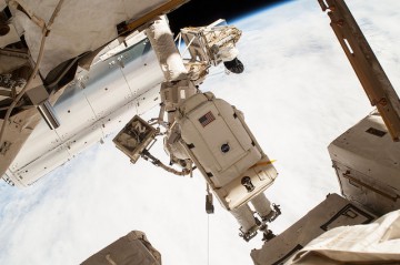 Terry Virts is positioned on an Articulating Portable Foot Restraint (APFR) on the External Stowage Platform (ESP)-2 during the Latching End Effector (LEE) Lube task on Wednesday's EVA-30. Photo Credit: NASA