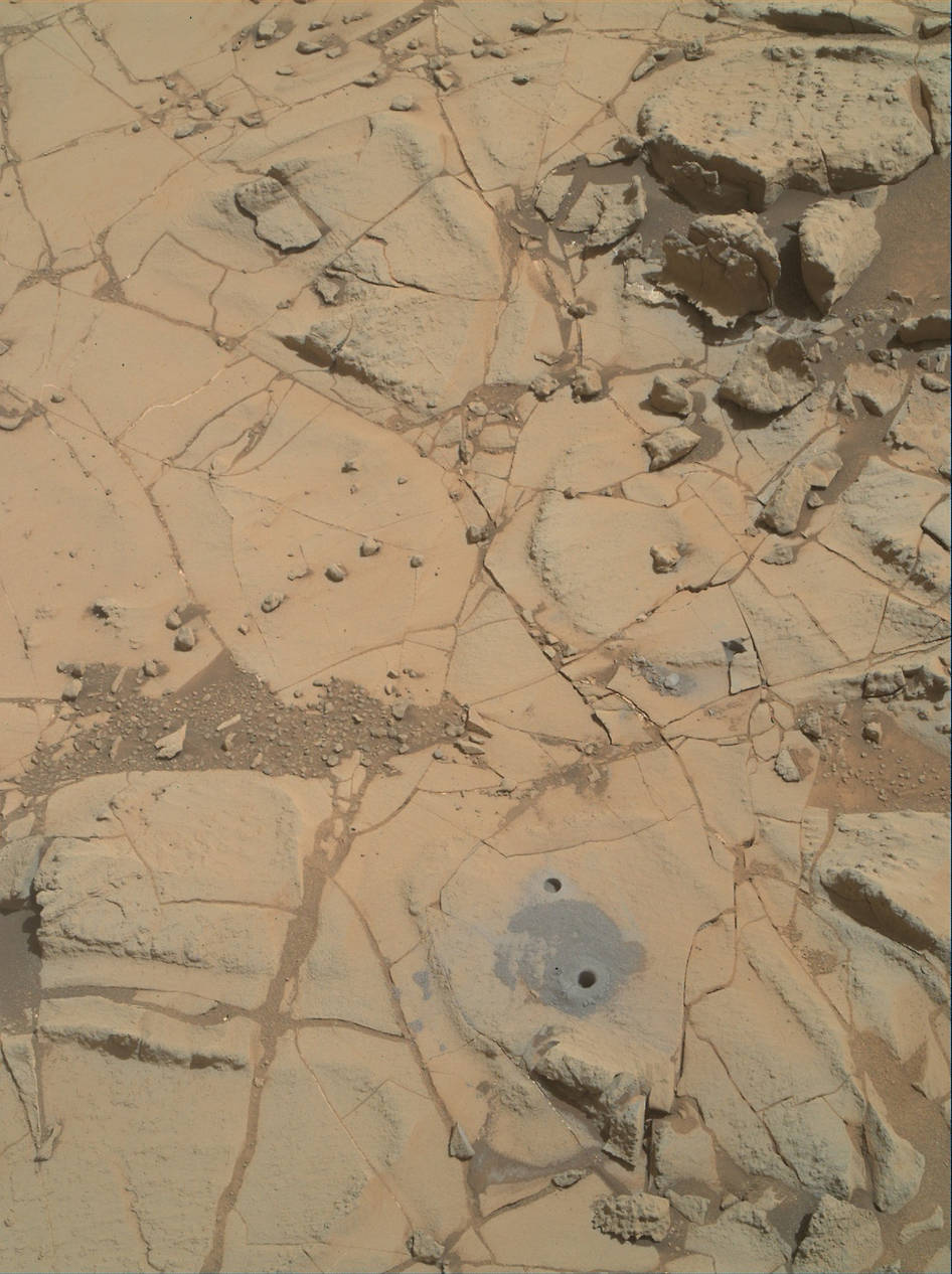 Gray cuttings from Curiosity's drilling into a target called "Mojave 2" are visible surrounding the sample-collection hole in this Jan. 31, 2015, image from the rover's MAHLI camera. This site in the "Pahrump Hills" outcrop provided the mission's second drilled sample of Mars' Mount Sharp. Image Credit: NASA/JPL-Caltech/MSSS