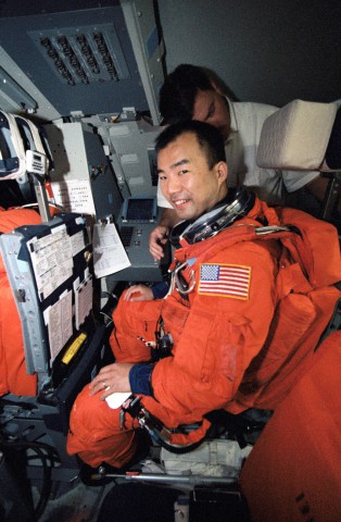 Soichi Noguchi takes his seat in the shuttle flight deck simulator during training in April 2002. Photo Credit: NASA