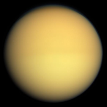 As seen by regular cameras or the human eye, Titan appears almost featureless due to the thick haze which envelopes the moon's atmosphere. Photo Credit: NASA/JPL-Caltech
