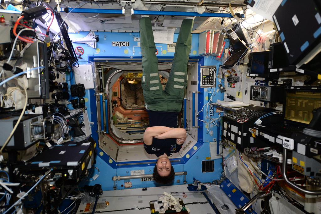 Expedition 42 crew member Samantha Cristoforetti of the European Space Agency (ESA) hanging onboard the ISS. Photo Credit: NASA