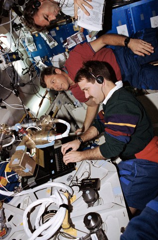From top to bottom, Bill Gregory, Steve Oswald and John Grunsfeld work in Endeavour's middeck. Photo Credit: NASA