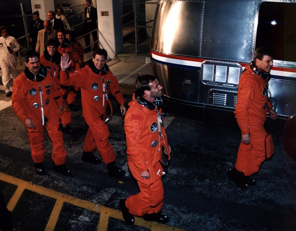Commander Steve Oswald leads the STS-67 crew out of the Operations and Checkout Building on the late evening of 1 March 1995, bound for a liftoff in the small hours of the following morning. Photo Credit: NASA