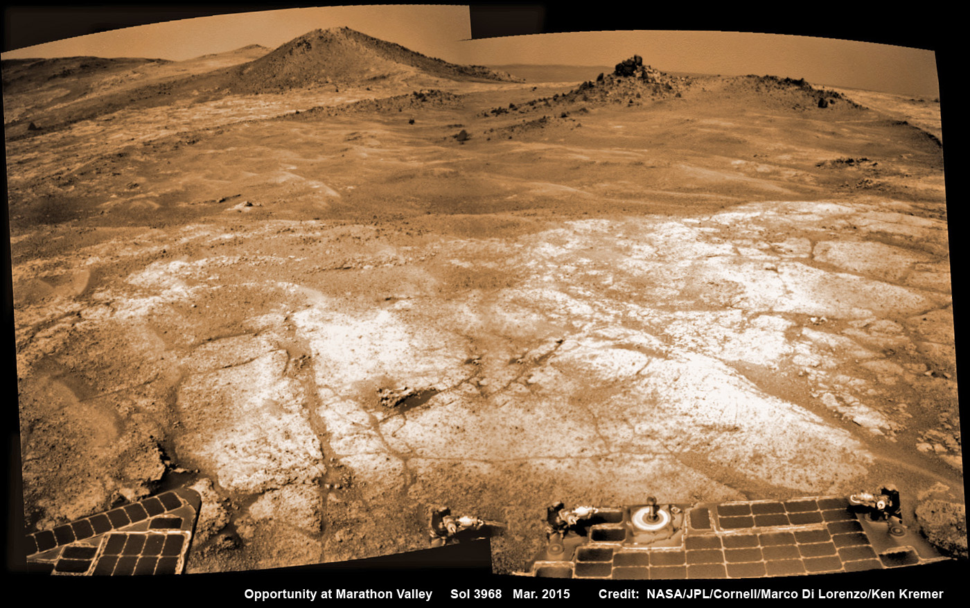 Opportunity’s view on the day the NASA rover exceeded the distance of a marathon on the surface of Mars on March 24, 2015, Sol 3968. Rover stands at Spirit of Saint Louis crater near mountaintop at Marathon Valley overlook and Martian cliffs at Endeavour crater holding deposits of water altered clay minerals.  This navcam camera photo mosaic was assembled from images taken on Sol 3968 (March 24, 2015) and colorized.  Credit: NASA/JPL/Cornell/Marco Di Lorenzo/Ken Kremer/kenkremer.com