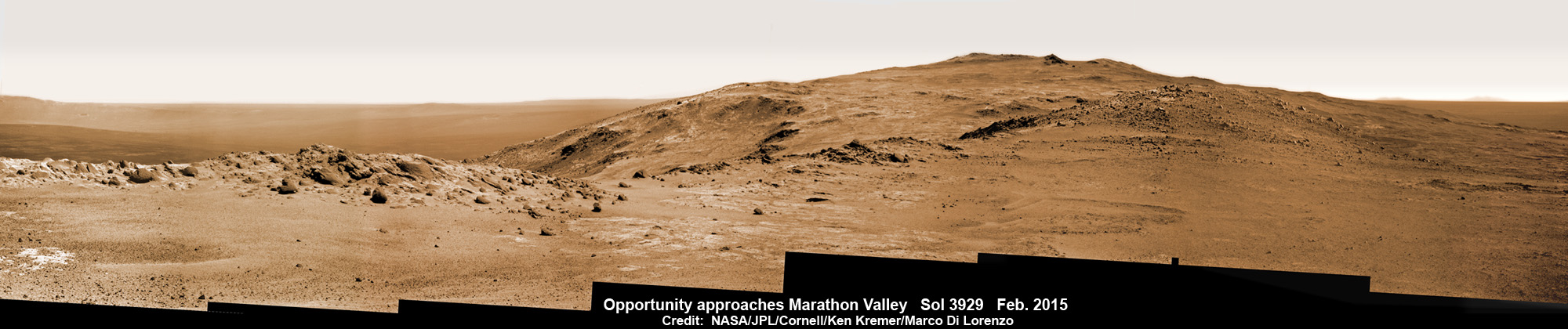 NASA Opportunity Rover looks ahead to Marathon Valley and Martian cliffs on Endeavour crater holding deposits of water altered clay minerals science treasure on Feb. 11, 2015.  Rover operates well after 11 Years trekking Mars.   This pancam camera photo mosaic was assembled from images taken on Sol 3929 (Feb. 11, 2015) and colorized.  Credit: NASA/JPL/Cornell/Ken Kremer/kenkremer.com/Marco Di Lorenzo