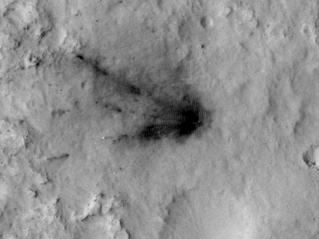 This image shows the blast zone where the sky crane from NASA's Curiosity rover mission hit the ground on Aug. 12, 2012, six days after setting the rover down in August 2012.  The dark scar's appearance subsequently faded over the next 30 months.  Image from HiRISE on NASA's Mars Reconnaissance Orbiter.  Credit:   NASA/JPL-Caltech/Univ. of Arizona