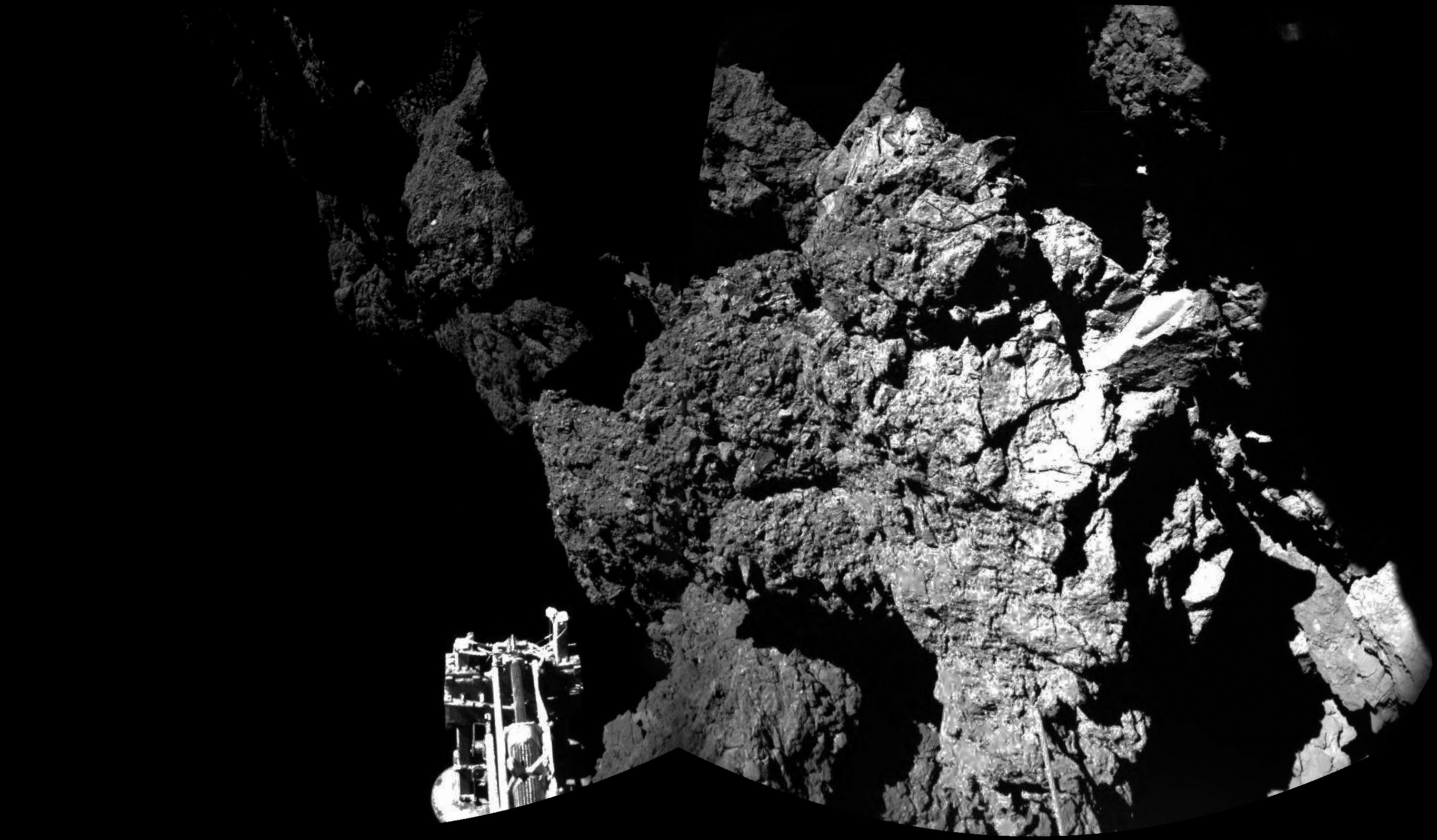 From ESA, "Welcome to a Comet": "Philae's view of the cliffs at Abydos. One of the lander's three feet can be seen in the foreground." Image Credit: ESA/Rosetta/Philae/CIVA