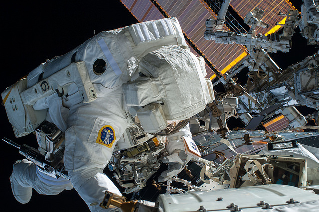 Terry Virts is pictured working on cable-routing activities in support of the future International Docking Adapters (IDAs) during EVA-29 on 21 February 2015. This was the first spacewalk in the 50th anniversary year since Alexei Leonov's pioneering EVA. Photo Credit: NASA
