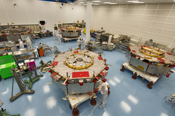  MMS Four Separate – View of all four spacecraft in the MMS Cleanroom getting prepared for stacking operations.  [Photo Credit NASA/Chris Gunn]