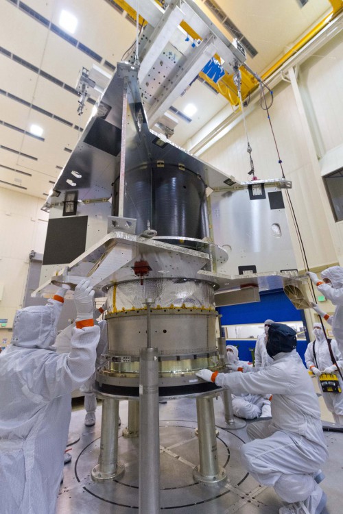 The OSIRIS-REx spacecraft core structure is successfully lowered and mated to the hydrazine propellant tank and boat tail assembly at Lockheed Martin, Denver, Colo. Photo Credit: Lockheed Martin