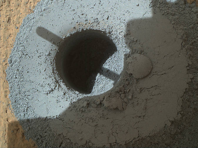 This hole, with a diameter slightly smaller than a U.S. dime, was drilled by NASA's Curiosity Mars rover into a rock target called "Telegraph Peak." The rock is located within the basal layer of Mount Sharp. The hole was drilled on Feb. 24, 2015.  Credit:  NASA/JPL-Caltech/MSSS