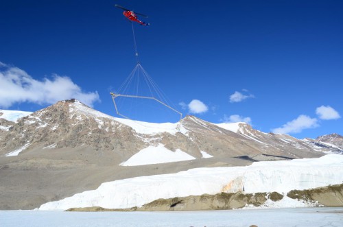 The SkyTEM sensor suspended beneath a helicopter over Blood Falls and the Taylor Glacier in Antarctica. Photo Credit: L. Jansan