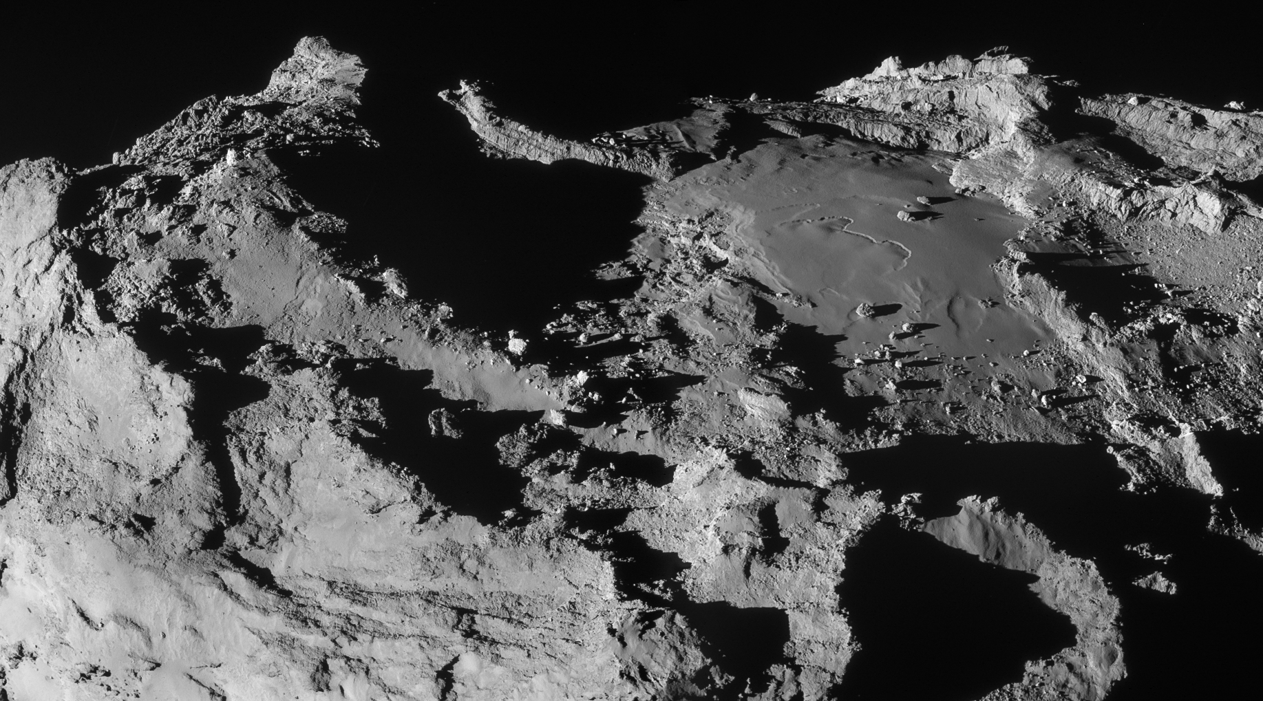 This stunning scene was created from two NAVCAM frames acquired at 19.9 km from the comet centre on 28 March. The scale is about 1.7 m/pixel and the image measures 3.1 x 1.7 km. The image has been adjusted for intensity and contrast, and the vignetting has been fixed. Credits: ESA/Rosetta/NAVCAM – CC BY-SA IGO 3.0