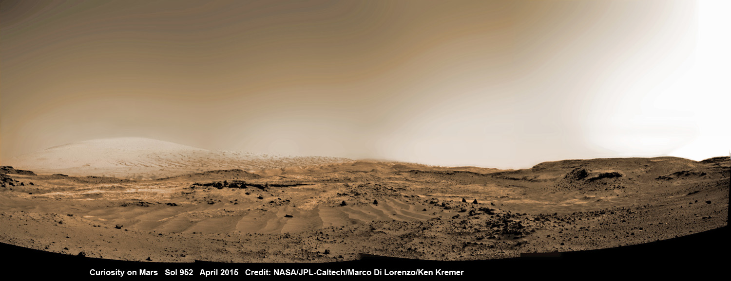 NASA's Curiosity Mars rover rolling across Mars at the foothills of Mount Sharp, seen in the background, in this mosaic of images taken on April 11, 2015 (Sol 952).  Navcam camera raw images stitched and colorized. Credit:  NASA/JPL-Caltech/ Marco Di Lorenzo/Ken Kremer/kenkremer.com