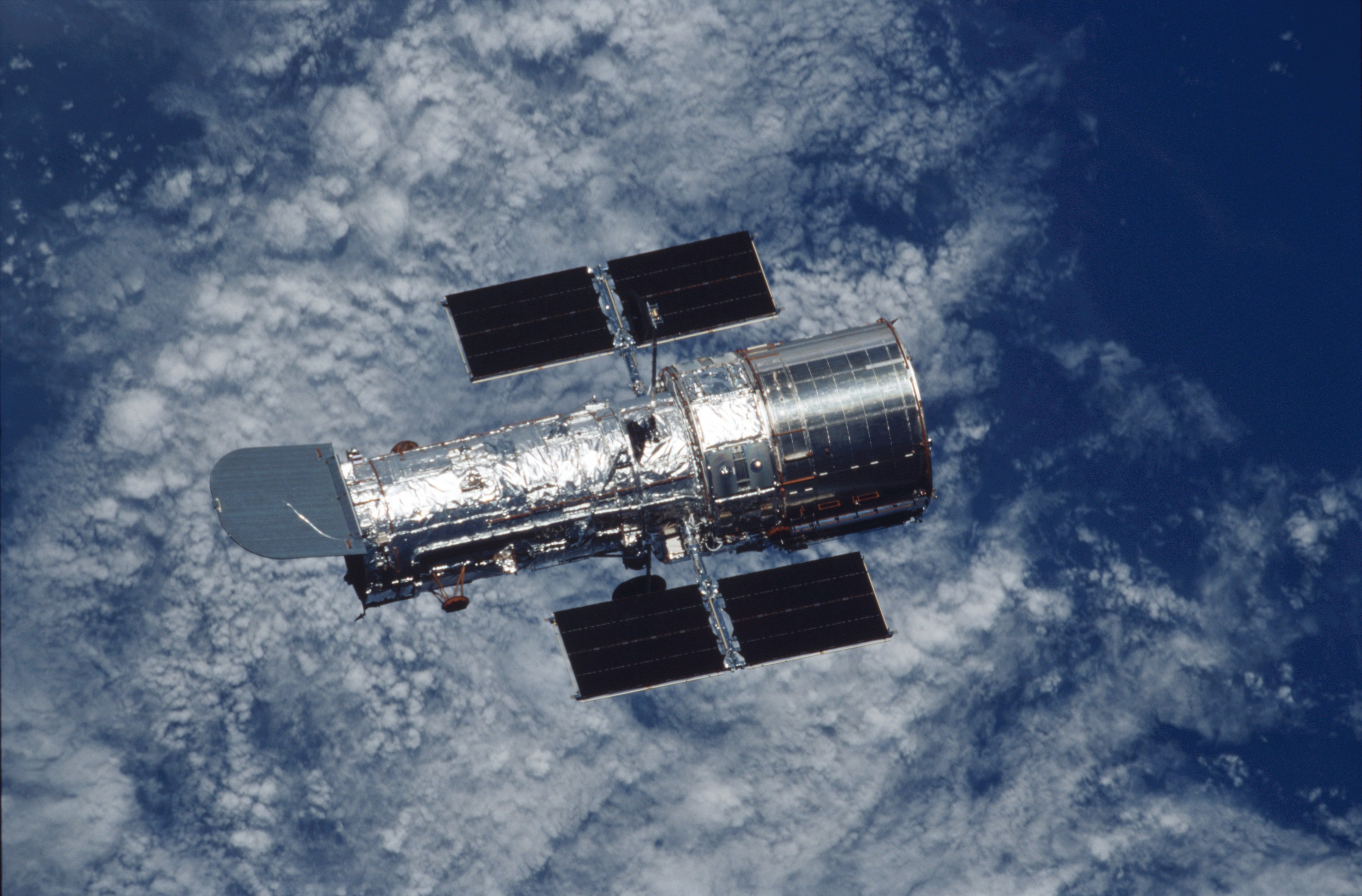 The Hubble Space Telescope appears to "fly" over Earth as it is photographed during STS-109. Photo Credit: NASA