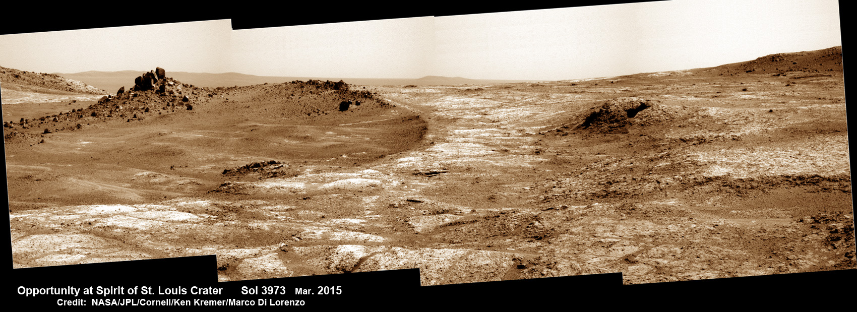 Opportunity arrives at Spirit of Saint Louis crater and peers into Marathon Valley and Endeavour crater from current location on Mars as of April 3, 2015 in this photo mosaic.  The crater, featuring an odd mound of rocks, is the gateway to Marathon Valley and exposures of water altered clay minerals.  This pancam camera photo mosaic was assembled from images taken on Sol 3973 (March 29, 2015) and colorized.  Credit: NASA/JPL/Cornell/ Ken Kremer/kenkremer.com/Marco Di Lorenzo